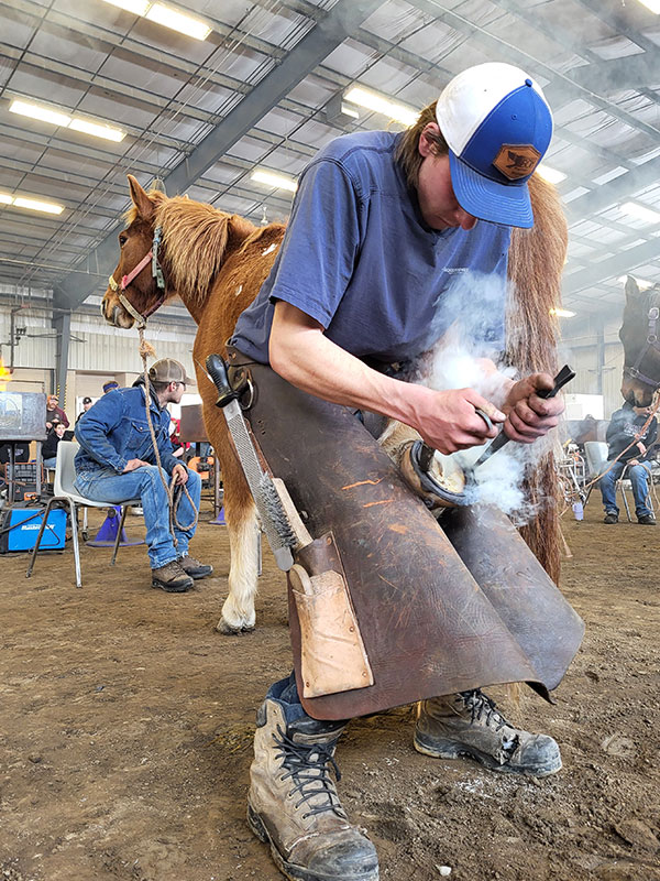 Matt Brett (current student), hot fitting his shoe, Division 1 shoeing round