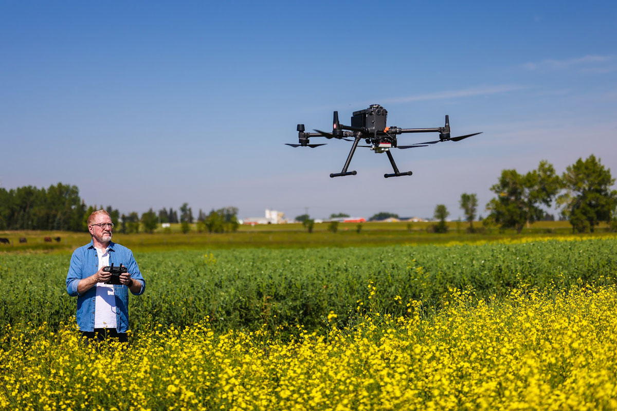 Researcher Flying a Drone on the Olds College Smart Farm