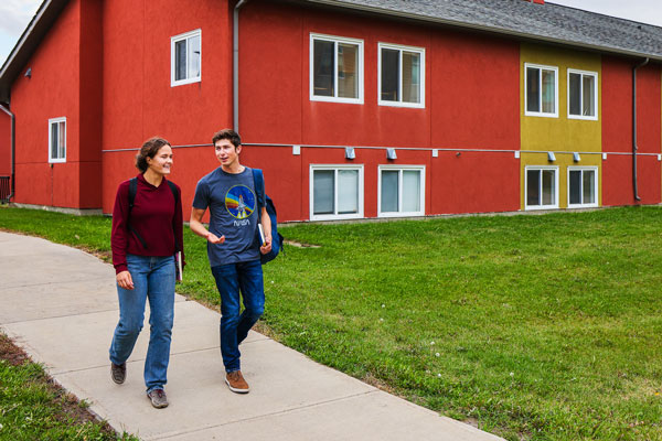 Students walking in front of the College Court Townhouses at Olds College